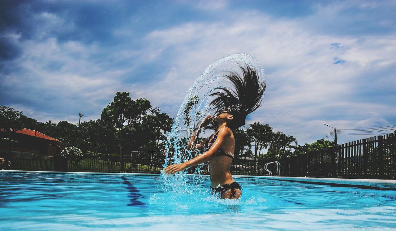 Woman jumping in water