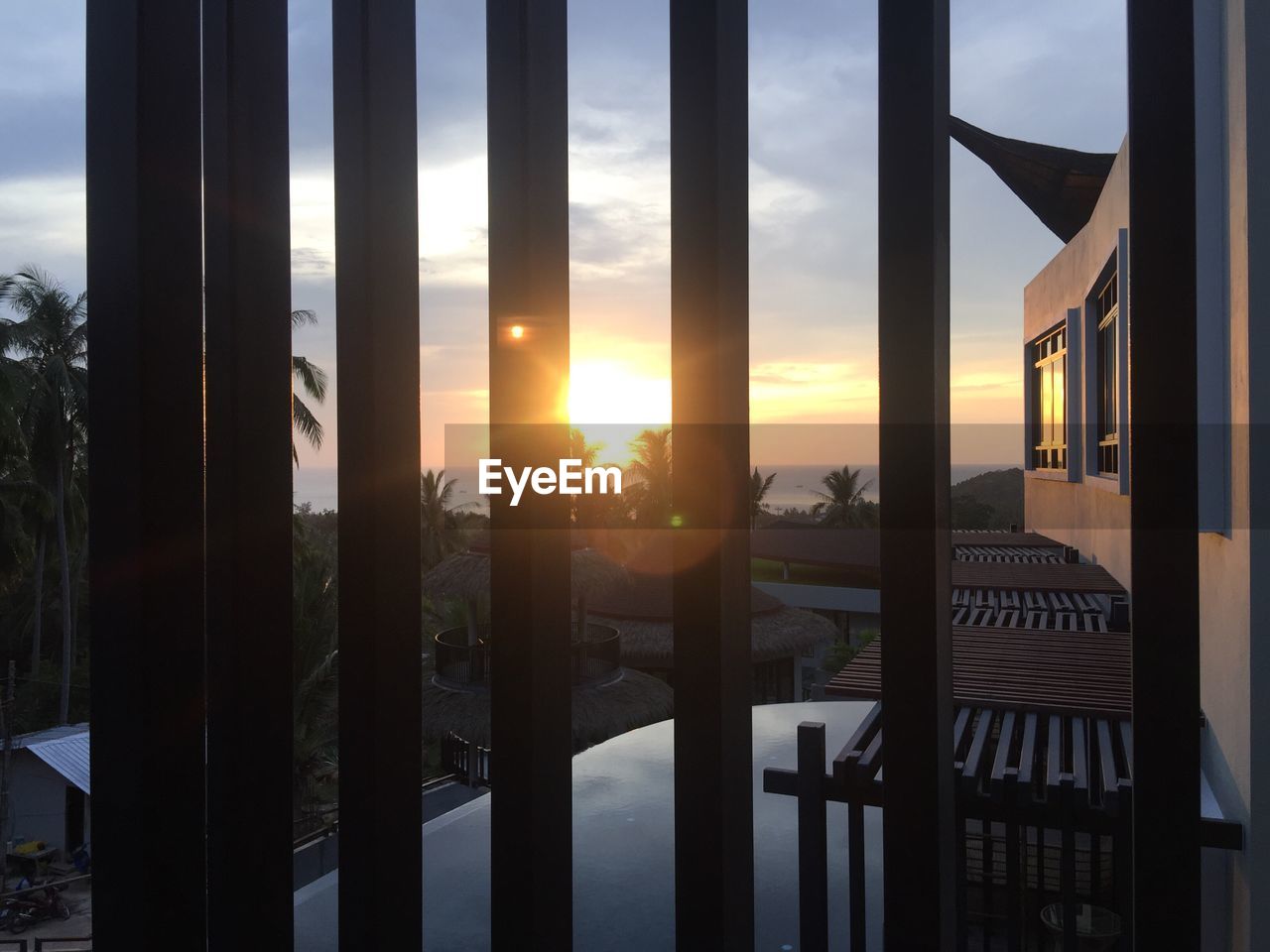 CLOSE-UP OF GATE AGAINST SUNSET