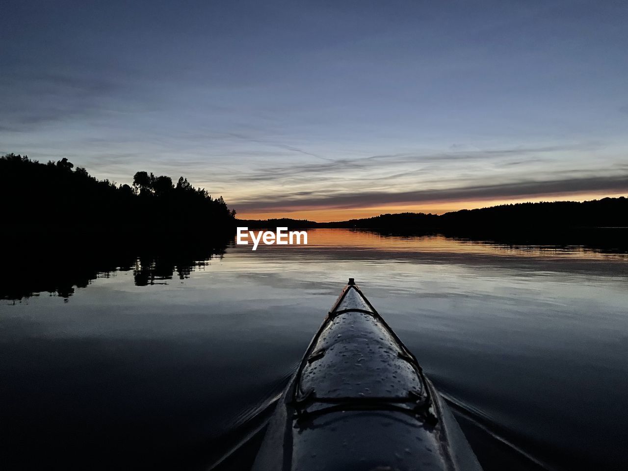 water, boat, sky, nature, scenics - nature, vehicle, reflection, beauty in nature, tranquility, lake, nautical vessel, transportation, tranquil scene, sunset, canoe, cloud, watercraft, dusk, tree, evening, no people, mode of transportation, outdoors, boating, kayak, landscape, non-urban scene, environment, travel, plant, horizon, idyllic, land, ship's bow, travel destinations, silhouette, paddle, adventure