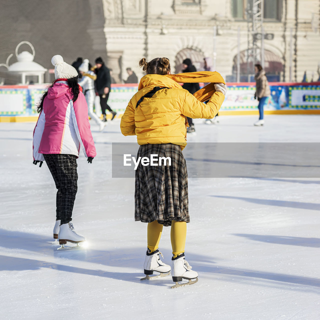 ice rink, winter sports, winter, ice skating, ice, cold temperature, full length, architecture, women, sports, child, group of people, childhood, skating, ice skate, snow, clothing, travel destinations, city, footwear, leisure activity, adult, sports equipment, female, lifestyles, day, built structure, recreation, building exterior, tourism, togetherness, person