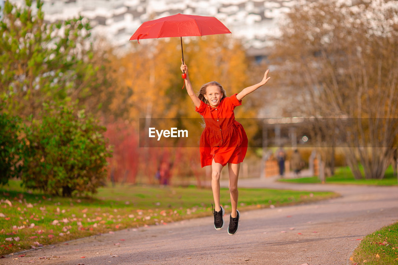 WOMAN WITH UMBRELLA IN RAIN