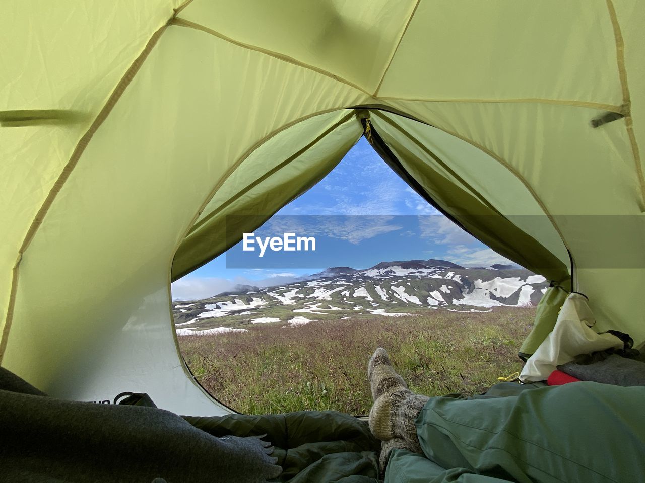 Low section of person relaxing in tent