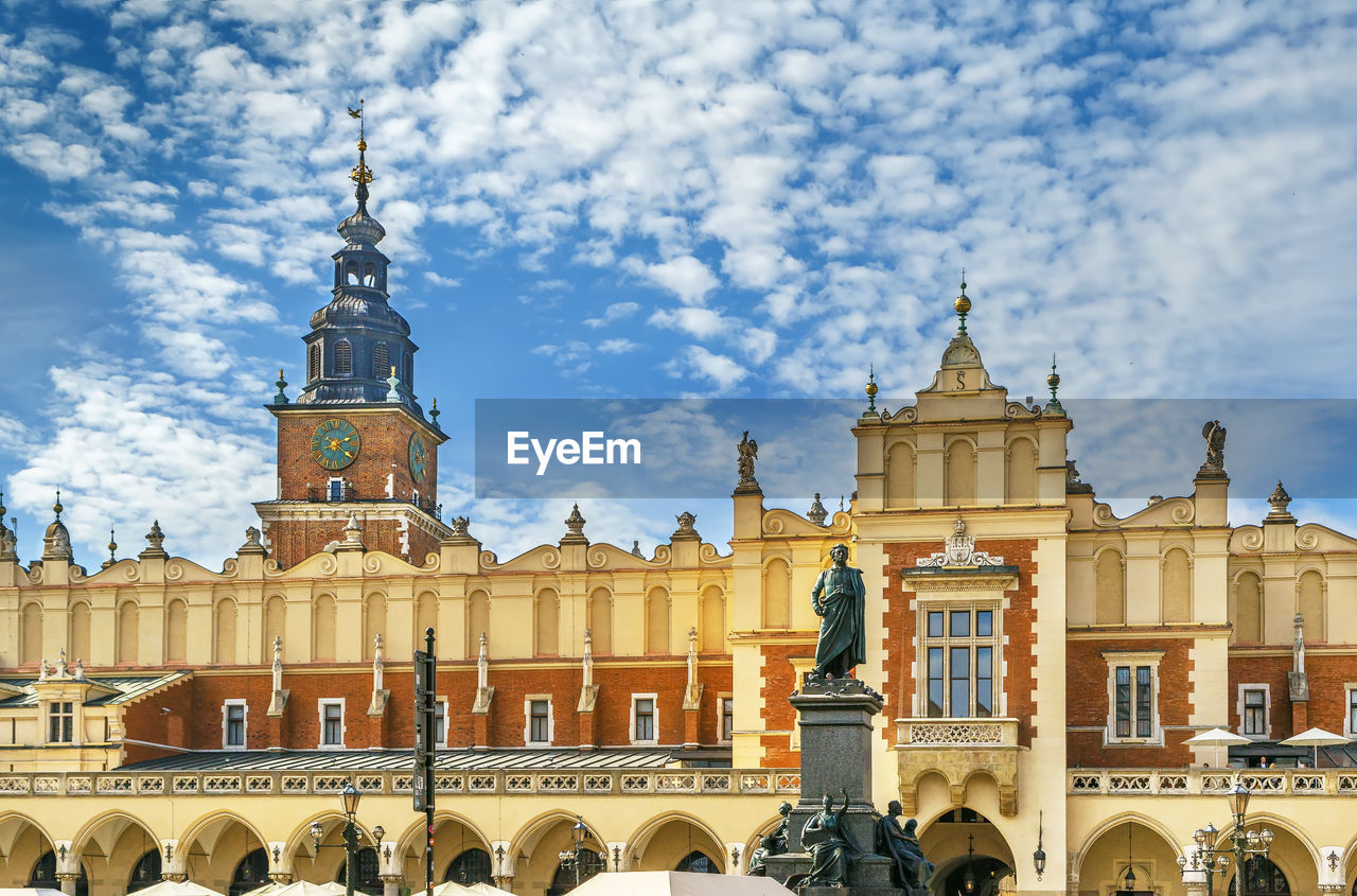 Krakow cloth hall and adam mickiewicz monument on main square in krakow, poland