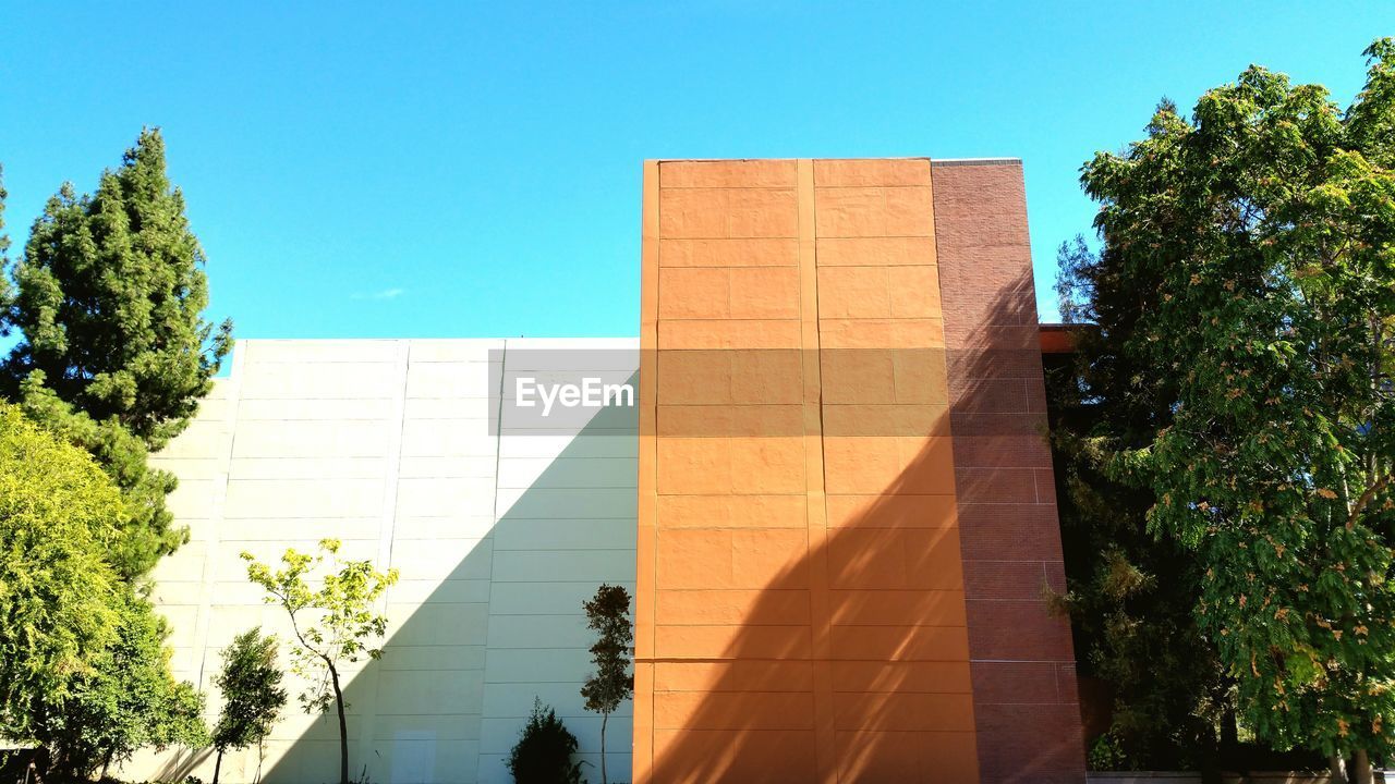 LOW ANGLE VIEW OF BUILT STRUCTURES AGAINST CLEAR BLUE SKY