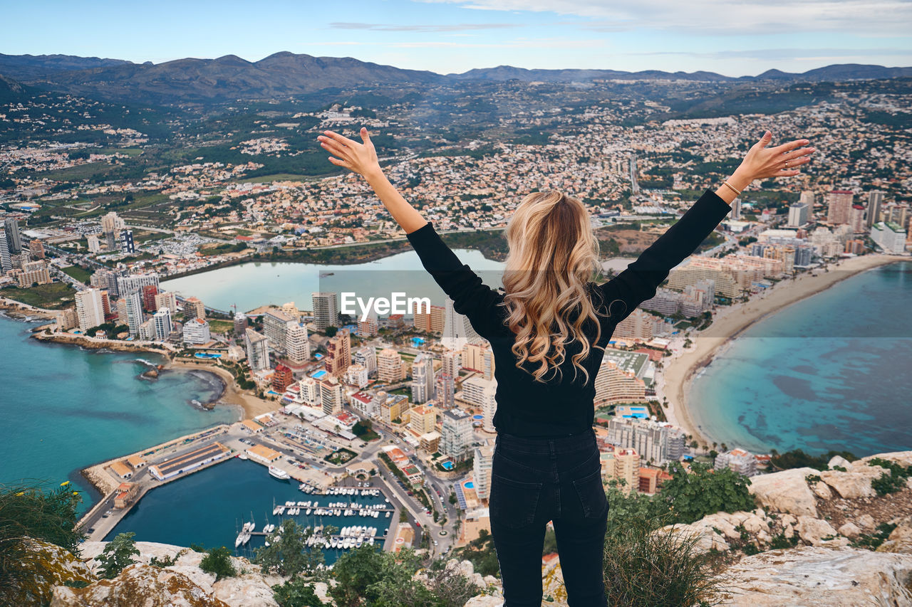 Rear view of woman looking at city buildings