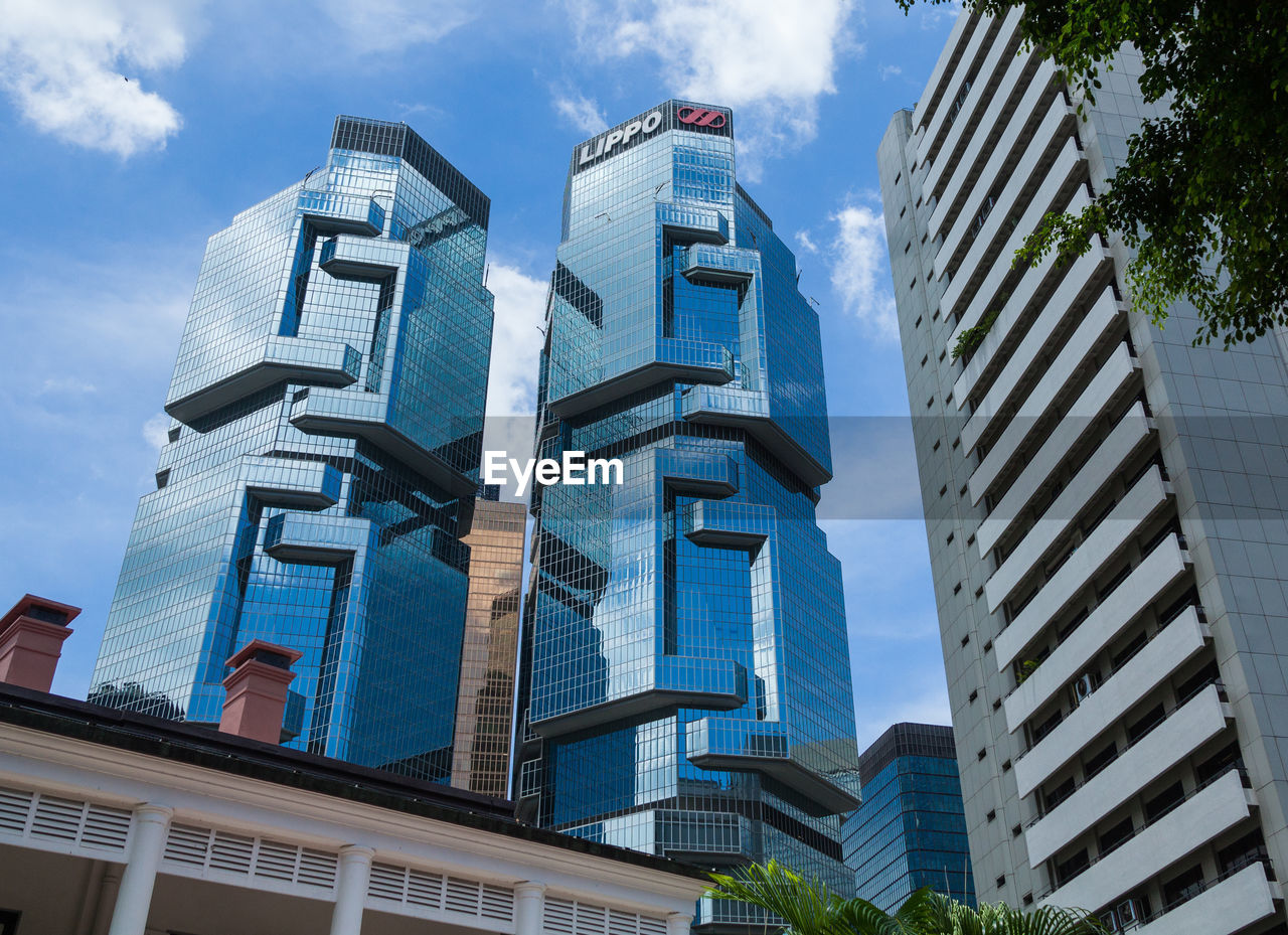 LOW ANGLE VIEW OF BUILDINGS AGAINST BLUE SKY