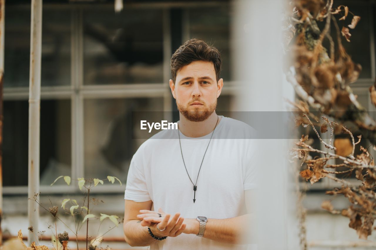 Portrait of young man standing outdoors