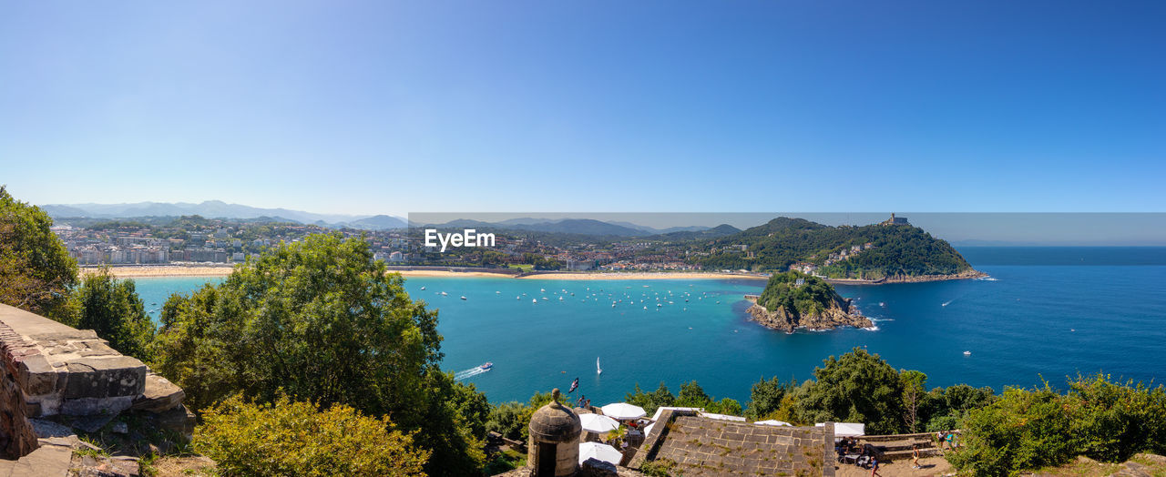 Scenic view of sea against clear blue sky