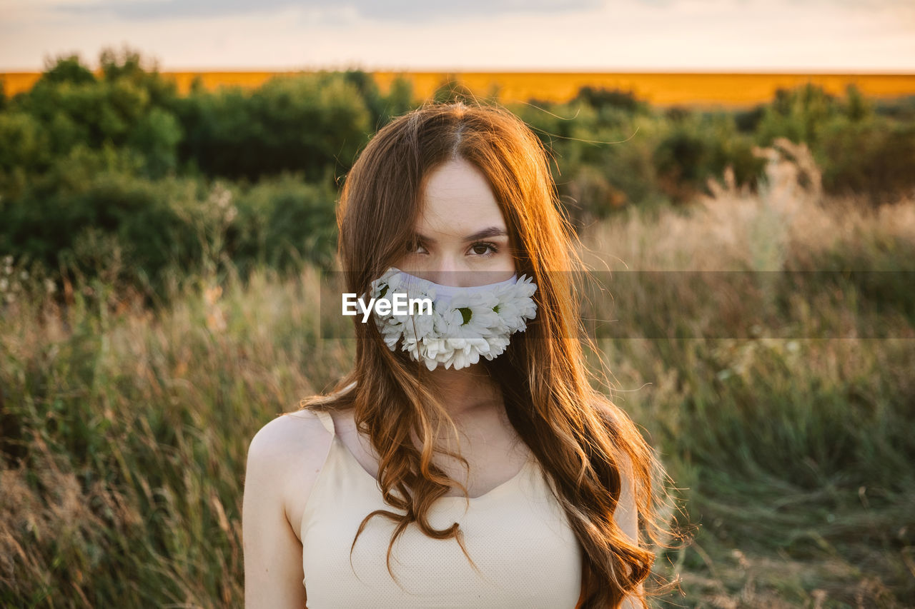 Statement masks, blinged out diy flower face mask design. girl in face mask decorated with flowers 