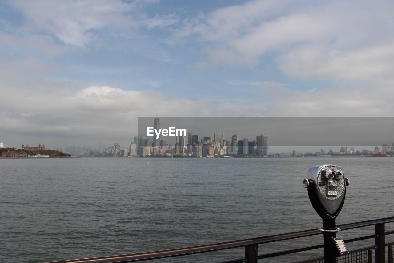 Coin operated binoculars with city in distant