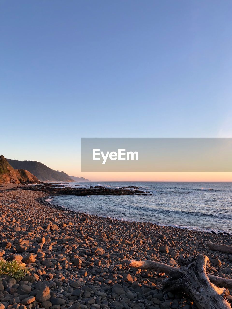 Scenic view of sea against clear sky during sunset