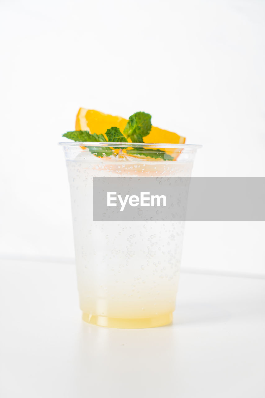 close-up of drink in glass on table against white background