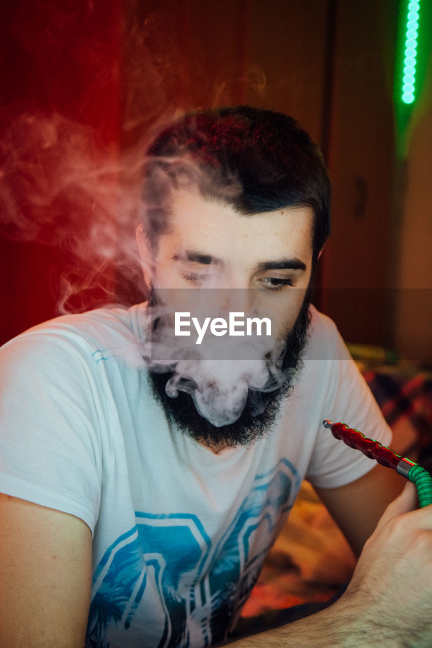 Close-up of man smoking hookah