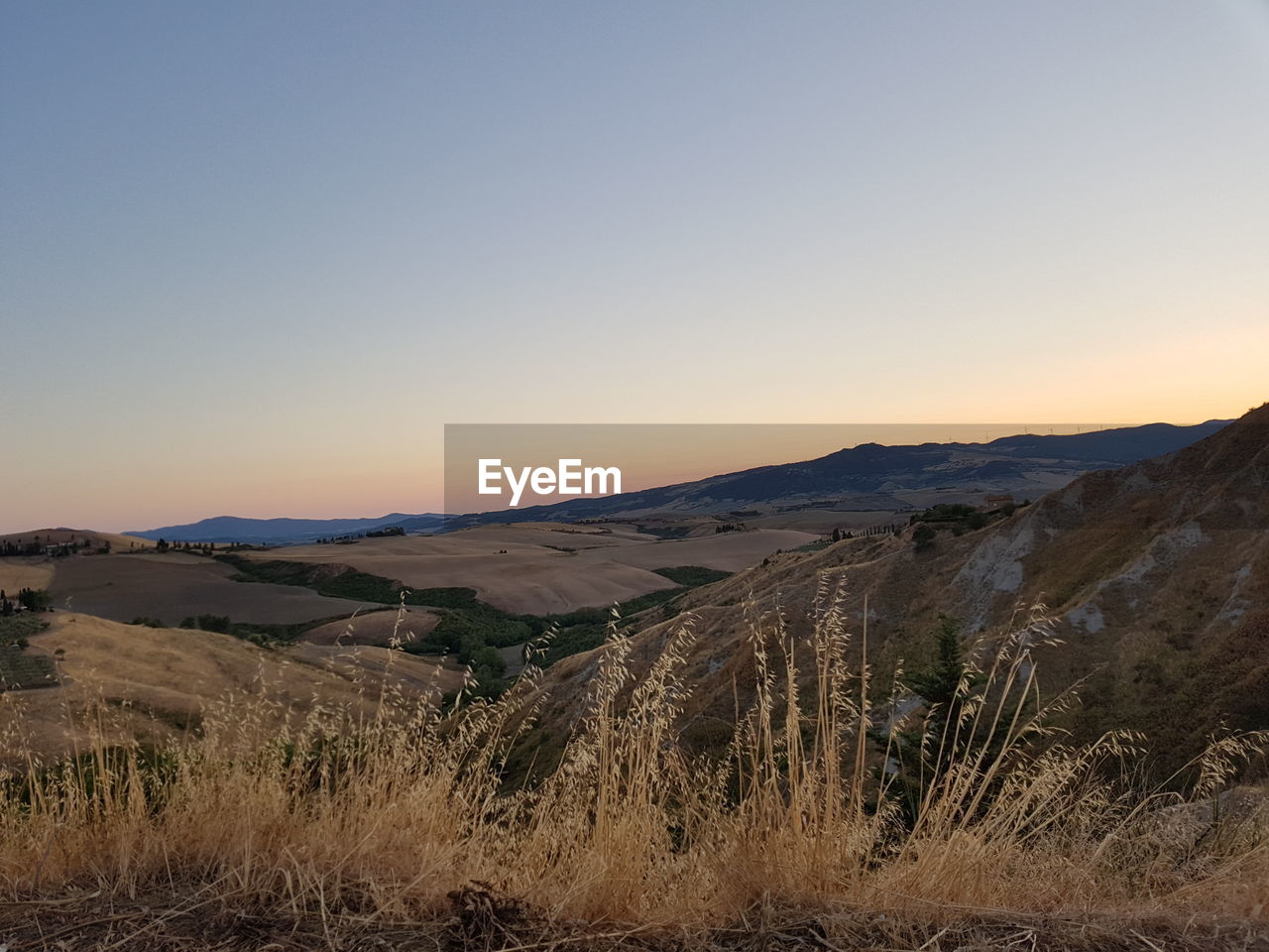 SCENIC VIEW OF LANDSCAPE AGAINST SKY DURING SUNSET