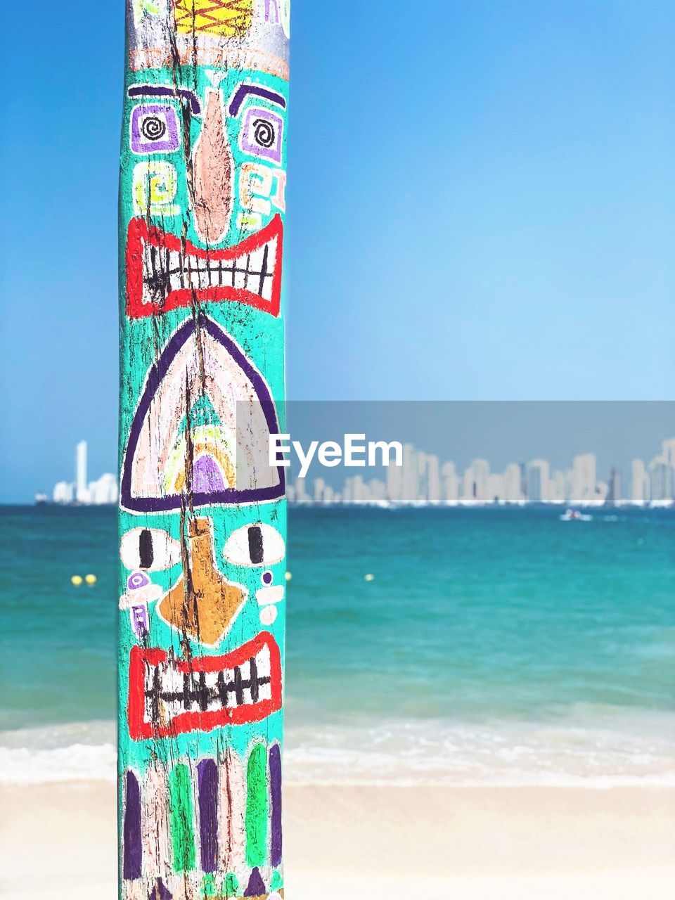 A funny wood art on cartagena beach against the city line