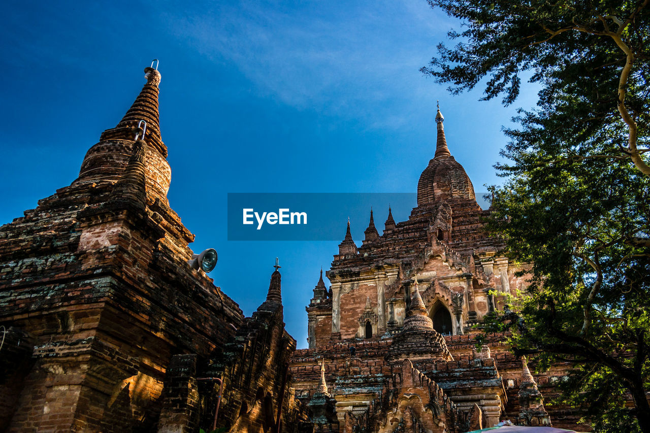 Low angle view of old buddhist temples against sky