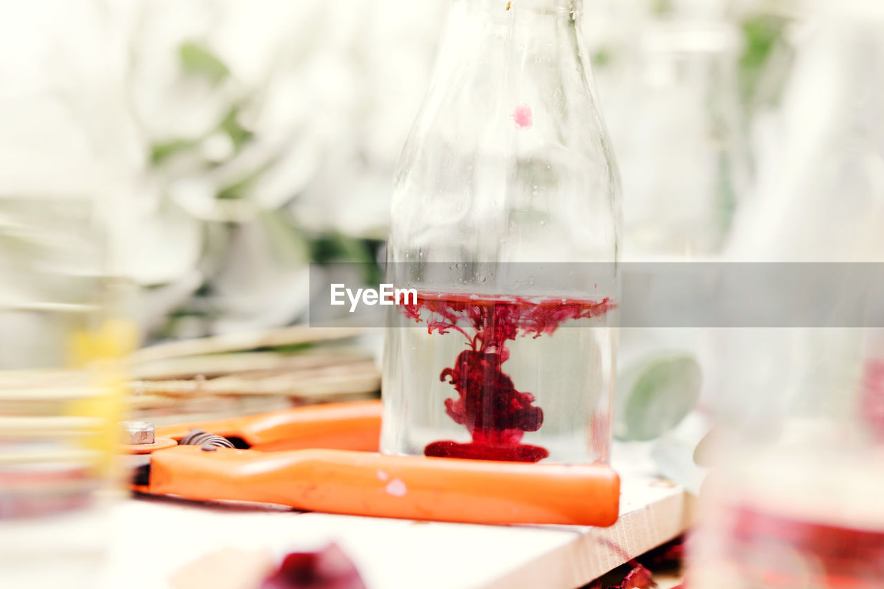 Close-up of red paint dissolving in water