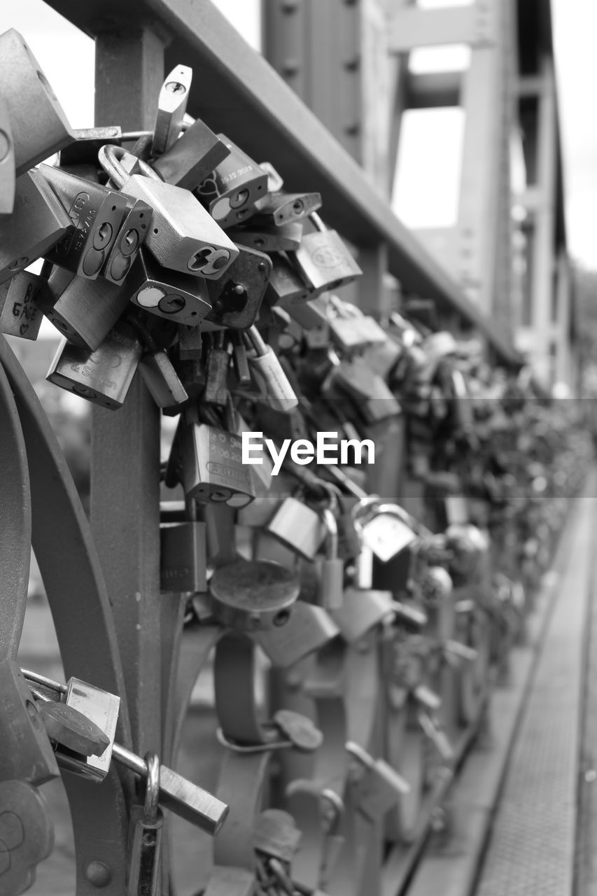 Close-up of padlocks hanging on railing