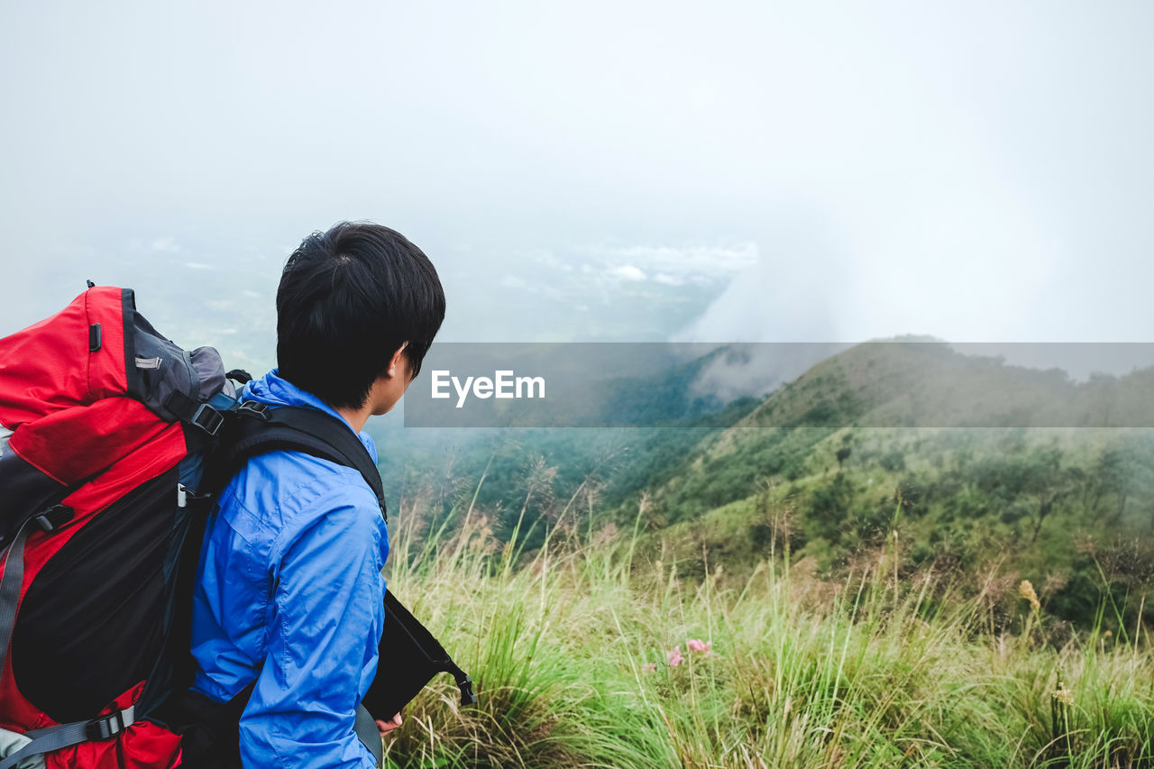 Side view of backpacker on mountain