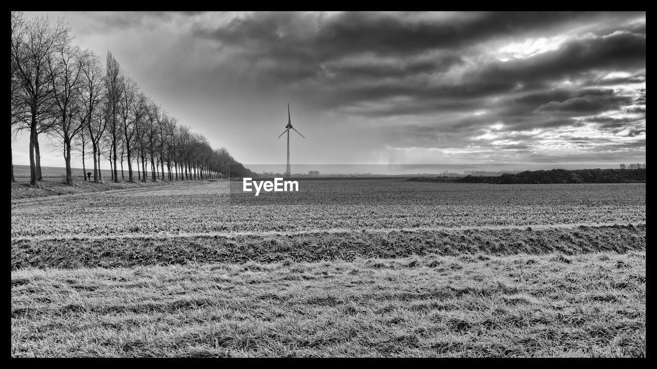 VIEW OF FIELD AGAINST CLOUDY SKY