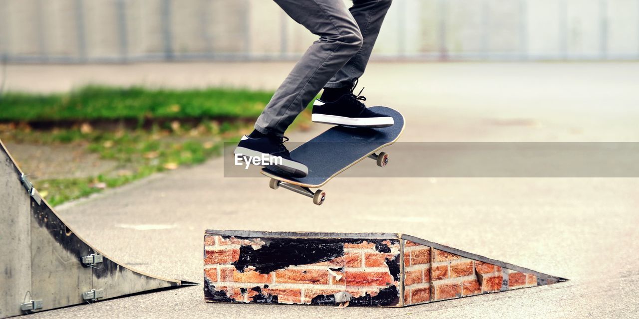 Low section of skateboarder jumping