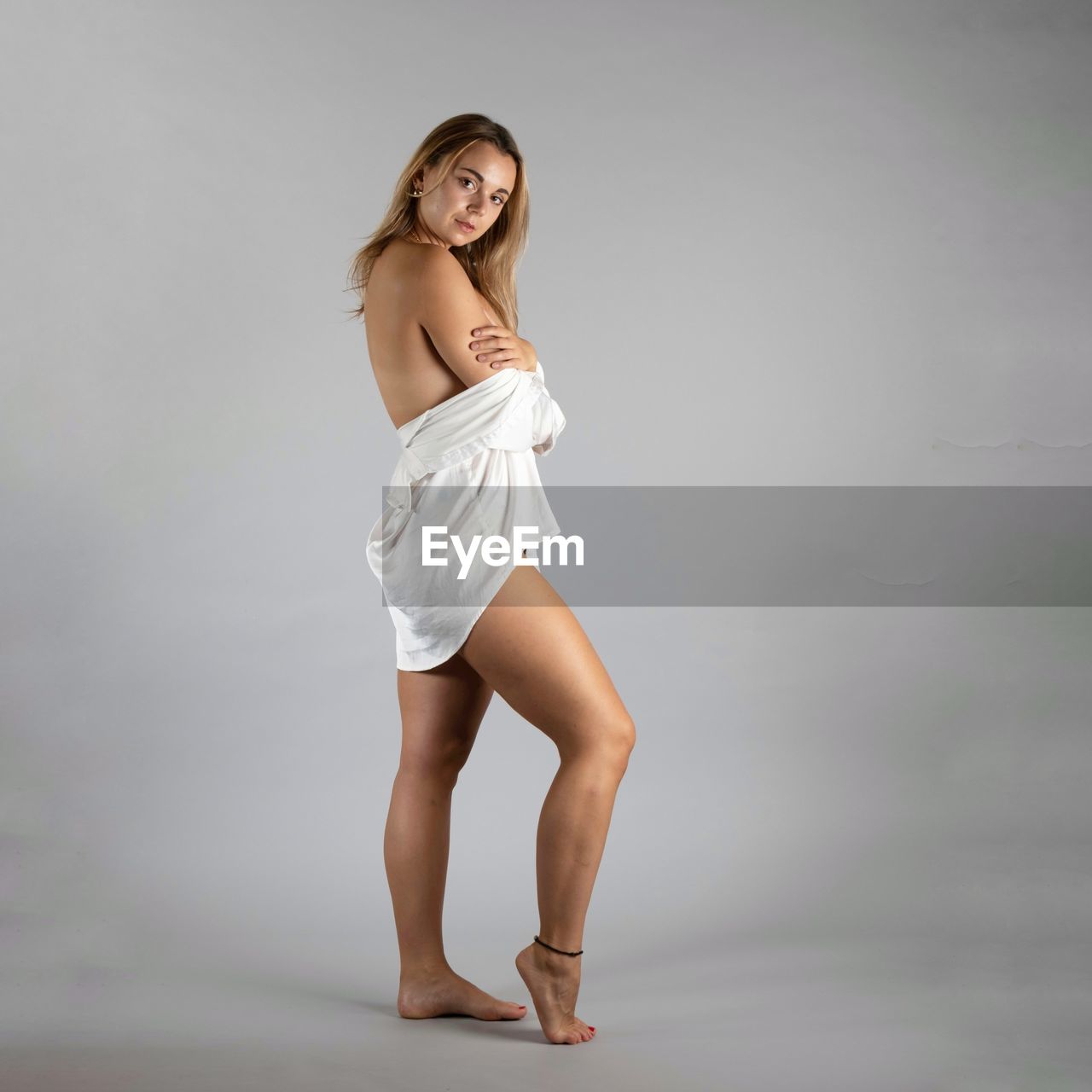 women, one person, adult, young adult, portrait, studio shot, full length, clothing, indoors, hairstyle, fashion, long hair, smiling, photo shoot, gray background, gray, looking at camera, happiness, limb, standing, human leg, female, person, brown hair, copy space, shoe, emotion, slim, elegance, cheerful, lifestyles, blond hair, dress, positive emotion, wellbeing, looking