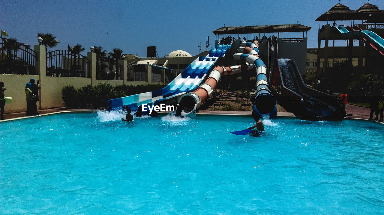 PEOPLE ENJOYING IN SWIMMING POOL