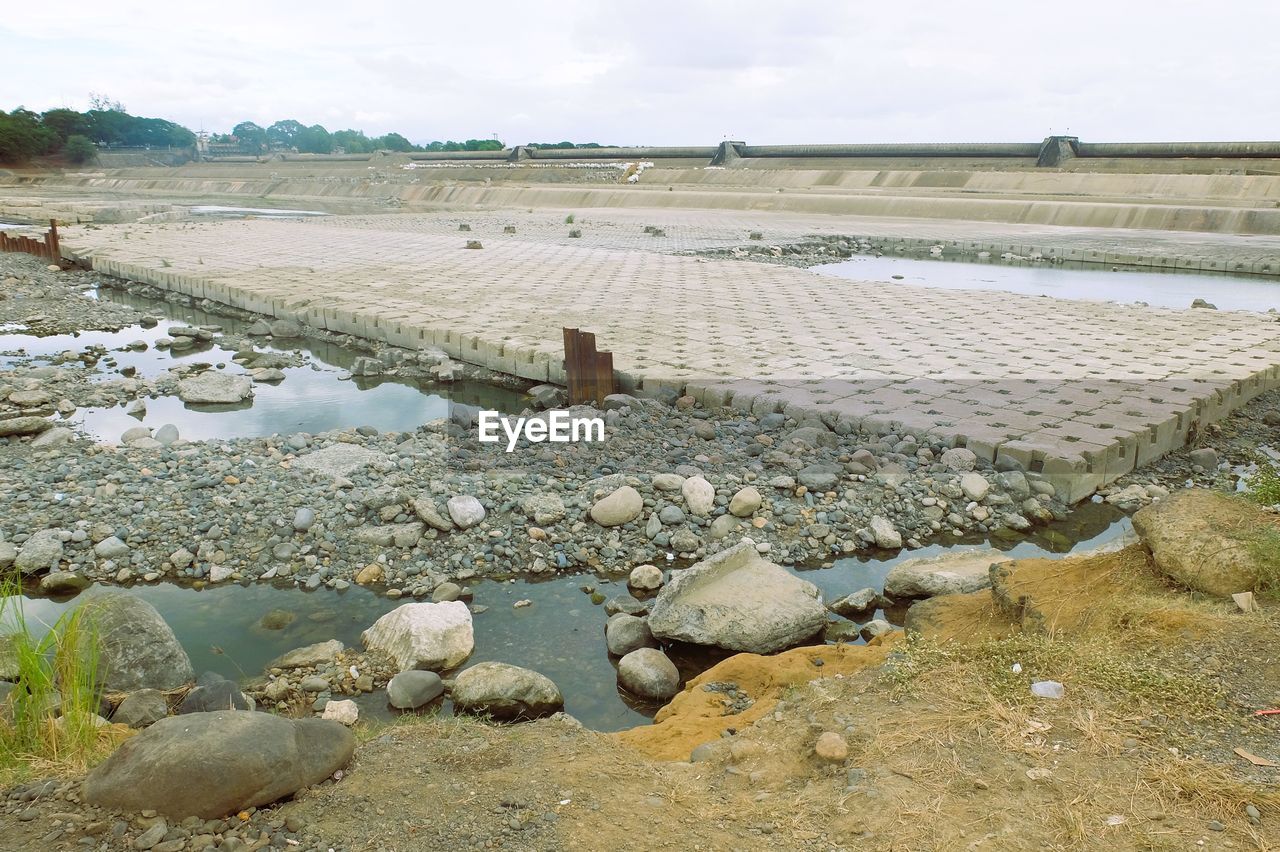 water, environment, nature, land, landscape, shore, sky, day, sea, coast, scenics - nature, agriculture, rock, no people, tranquility, outdoors, beauty in nature, rural scene, cloud, beach, tranquil scene, stone, wetland