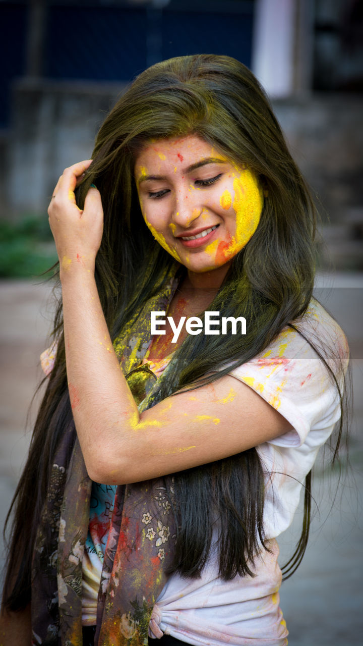 Young woman with powdered paint during holi