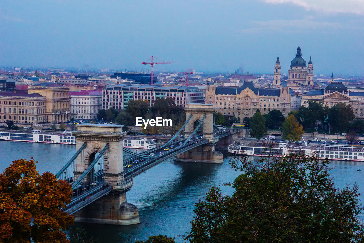 Chain bridge over river danube against sky