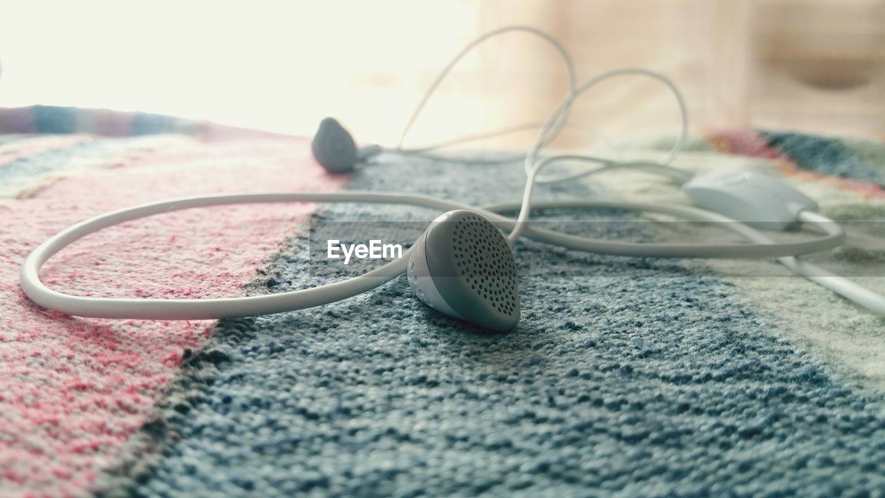 Close-up of in-ear headphones on table