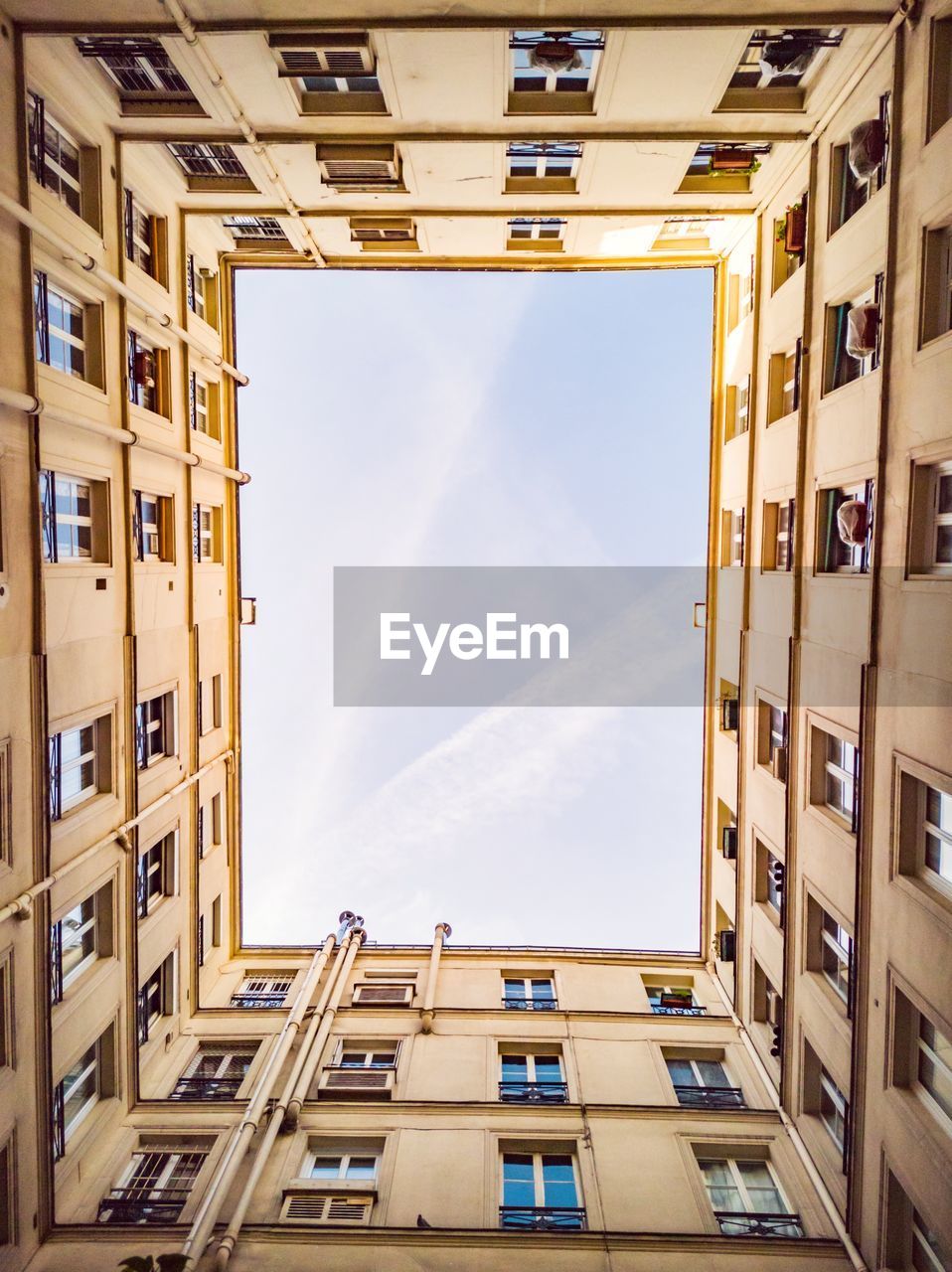 Directly below shot of buildings against sky