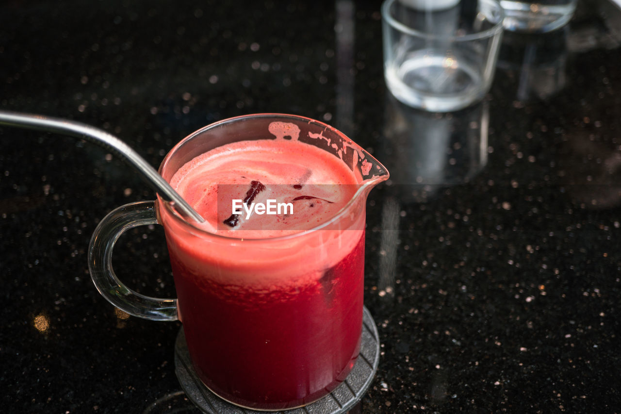 HIGH ANGLE VIEW OF DRINK WITH GLASS