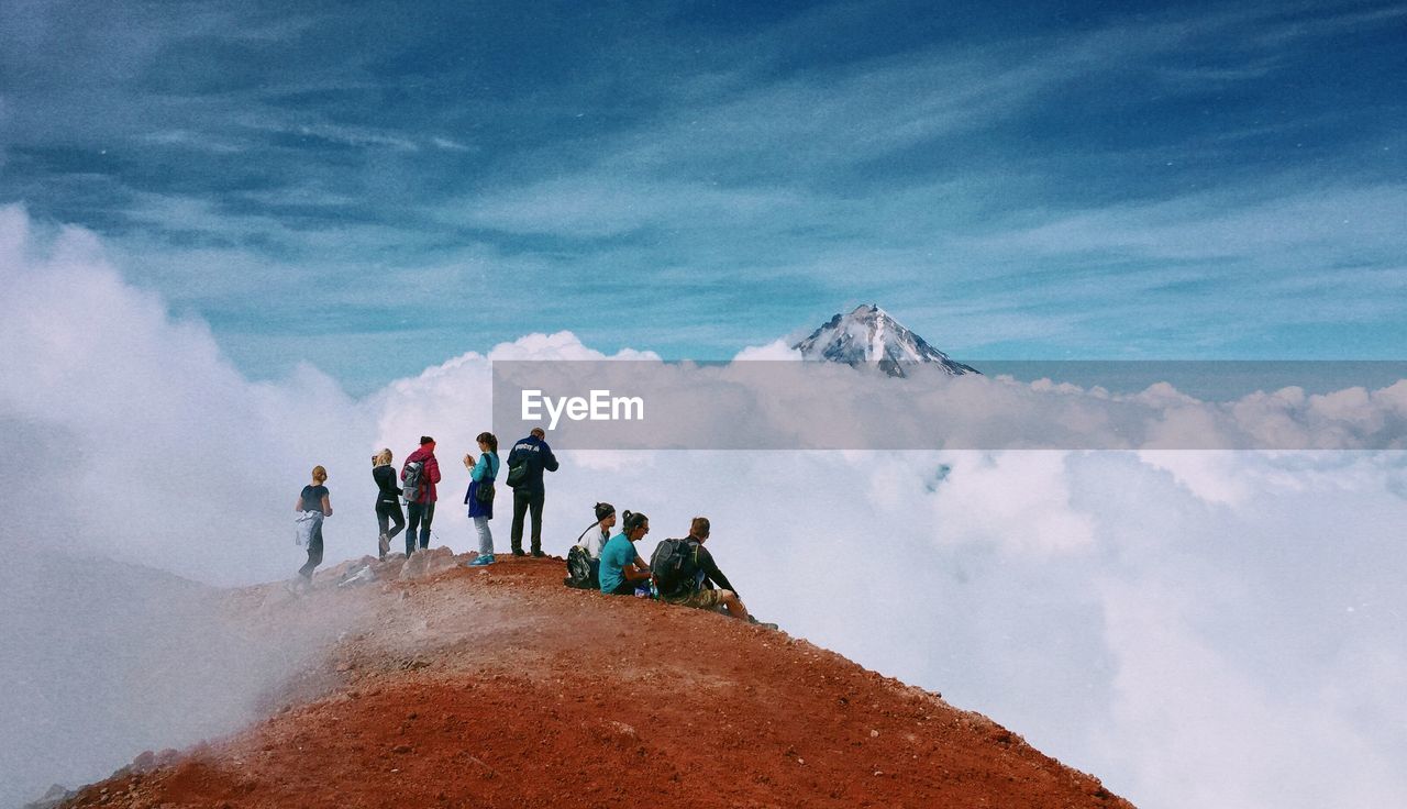 People on mountain against sky