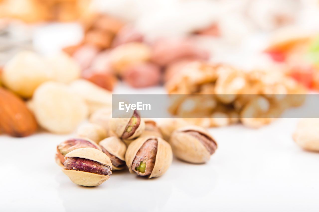 Close-up of fresh pistachios on white table