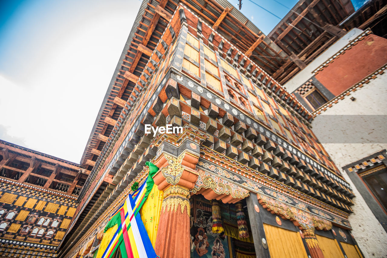 LOW ANGLE VIEW OF TEMPLE AGAINST BUILDING