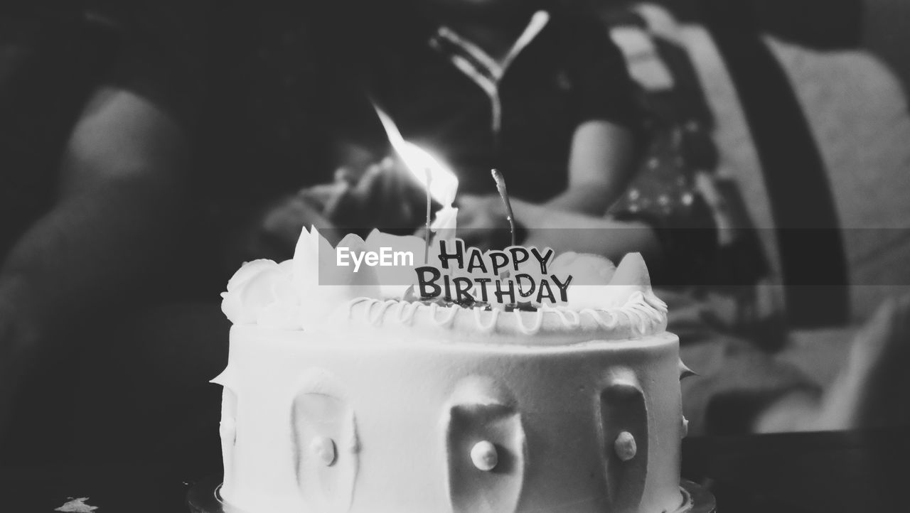 CLOSE-UP OF BIRTHDAY CAKE WITH TEXT ON TABLE