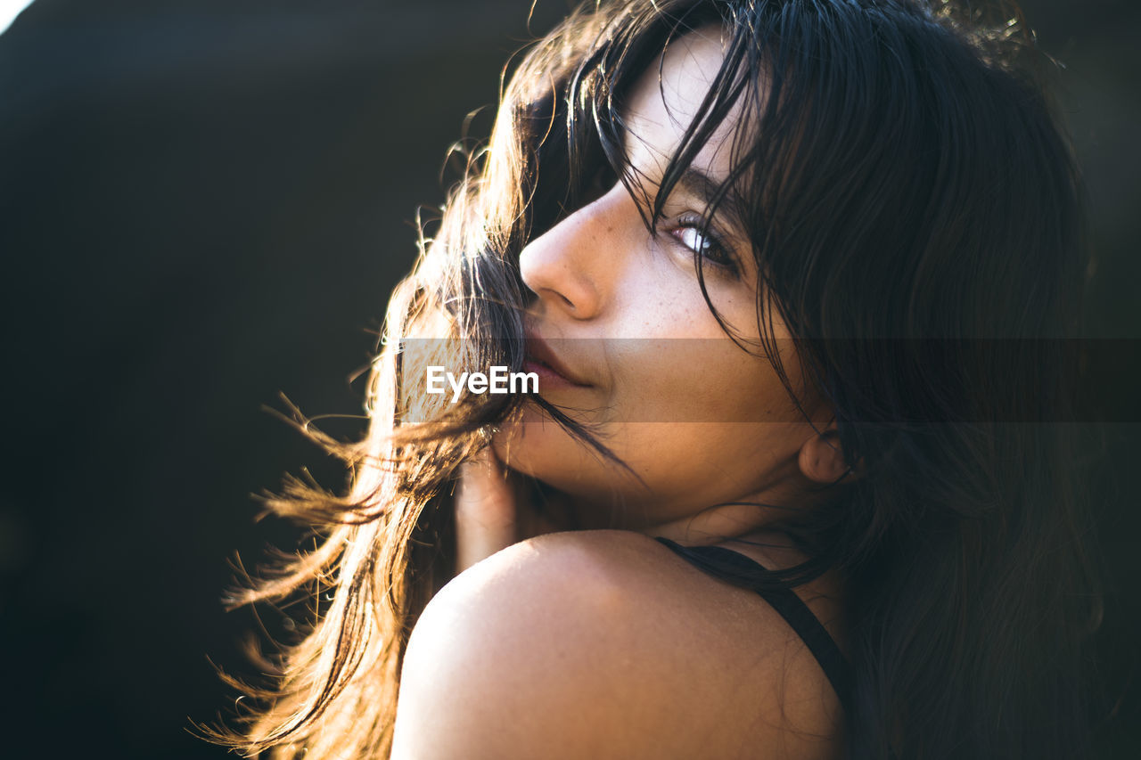 Young latina woman portrait at golden hour in summertime