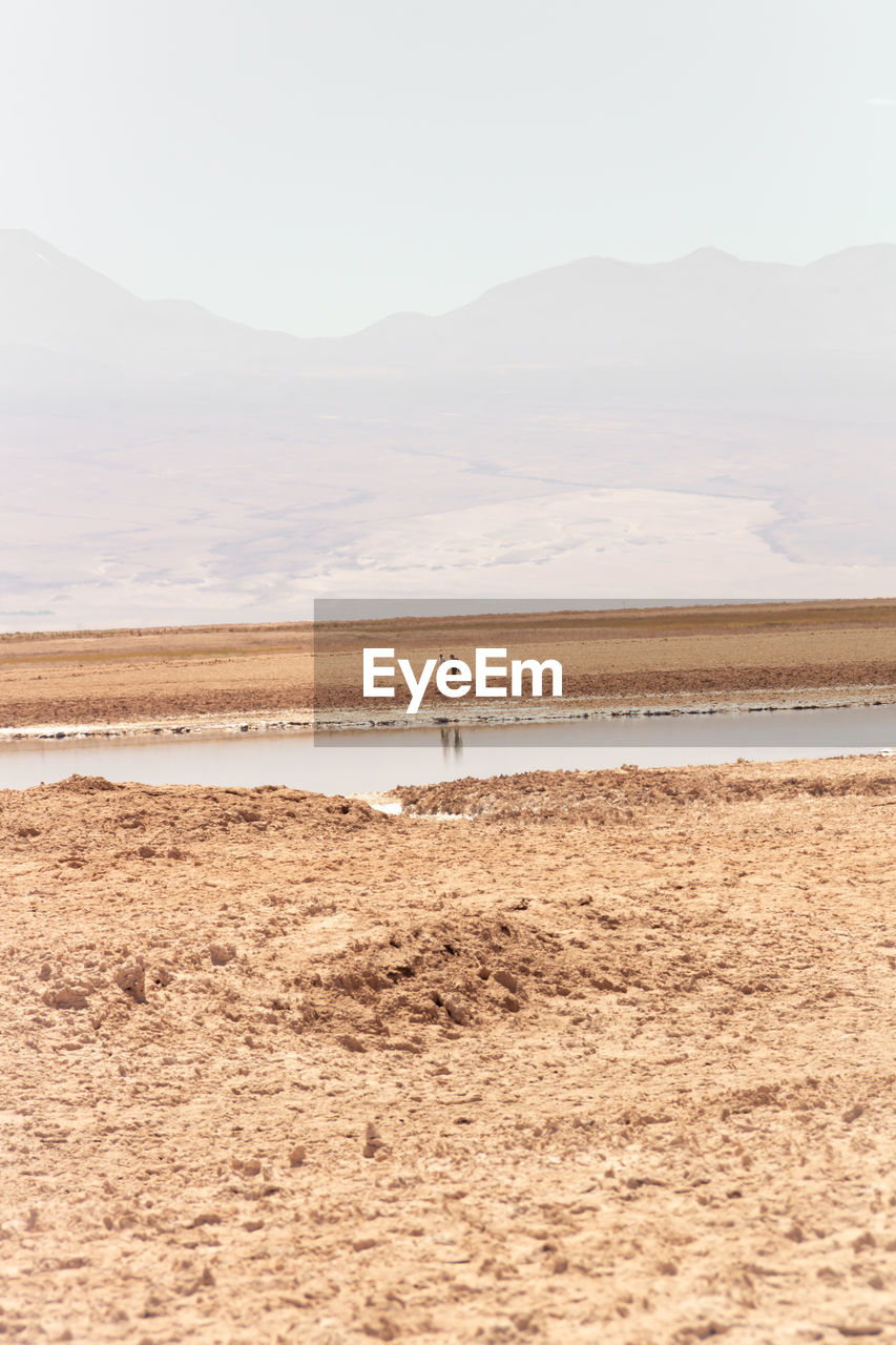 Couple walking hand in hand in the atacama desert