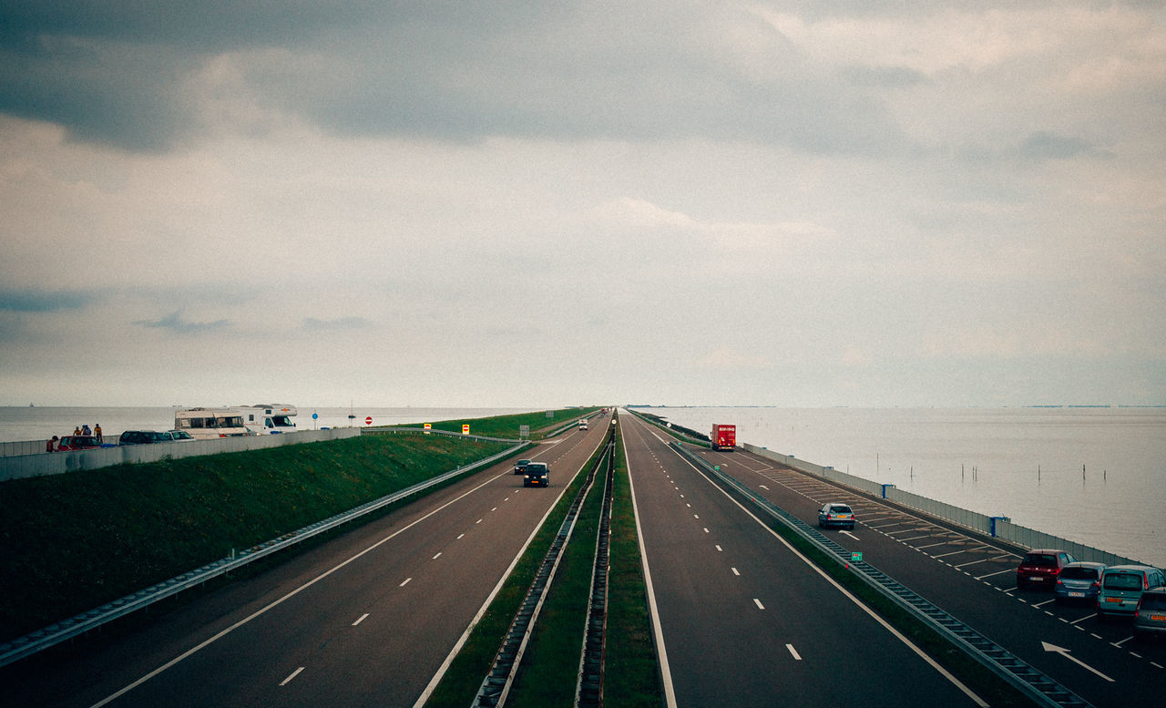 Highway against cloudy sky