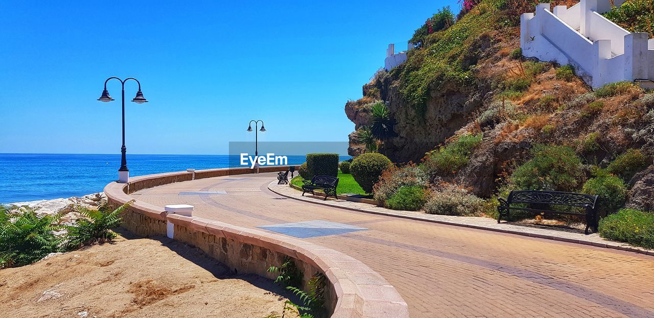 ROAD BY SEA AGAINST BLUE SKY