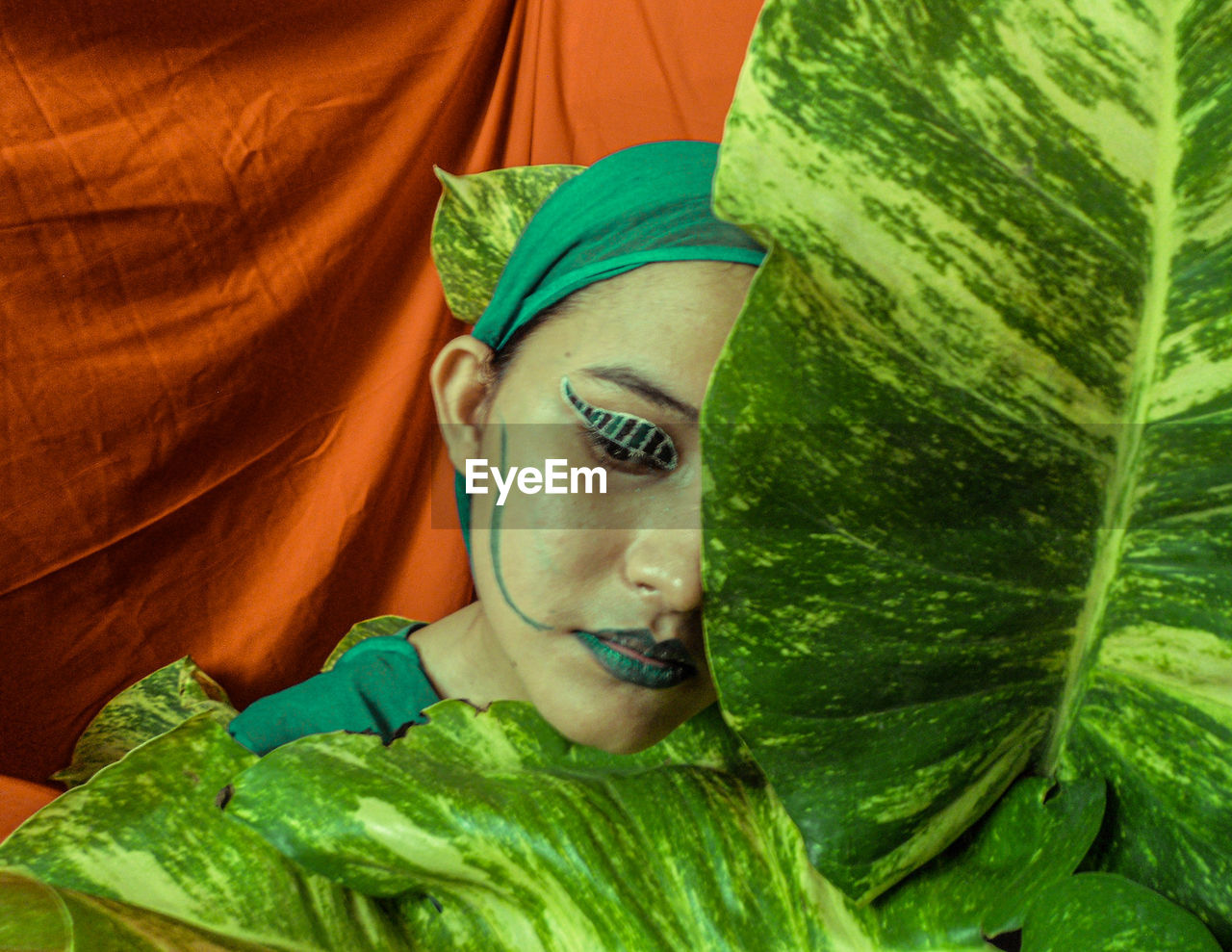 Close-up portrait of a woman portraying the stage of pupa of metamorphosis of a butterfly