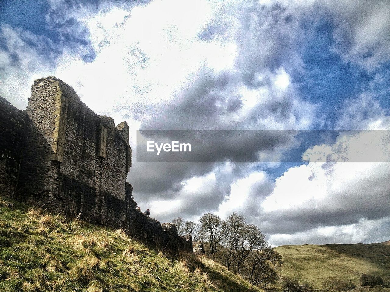 LOW ANGLE VIEW OF HOUSE AGAINST CLOUDY SKY