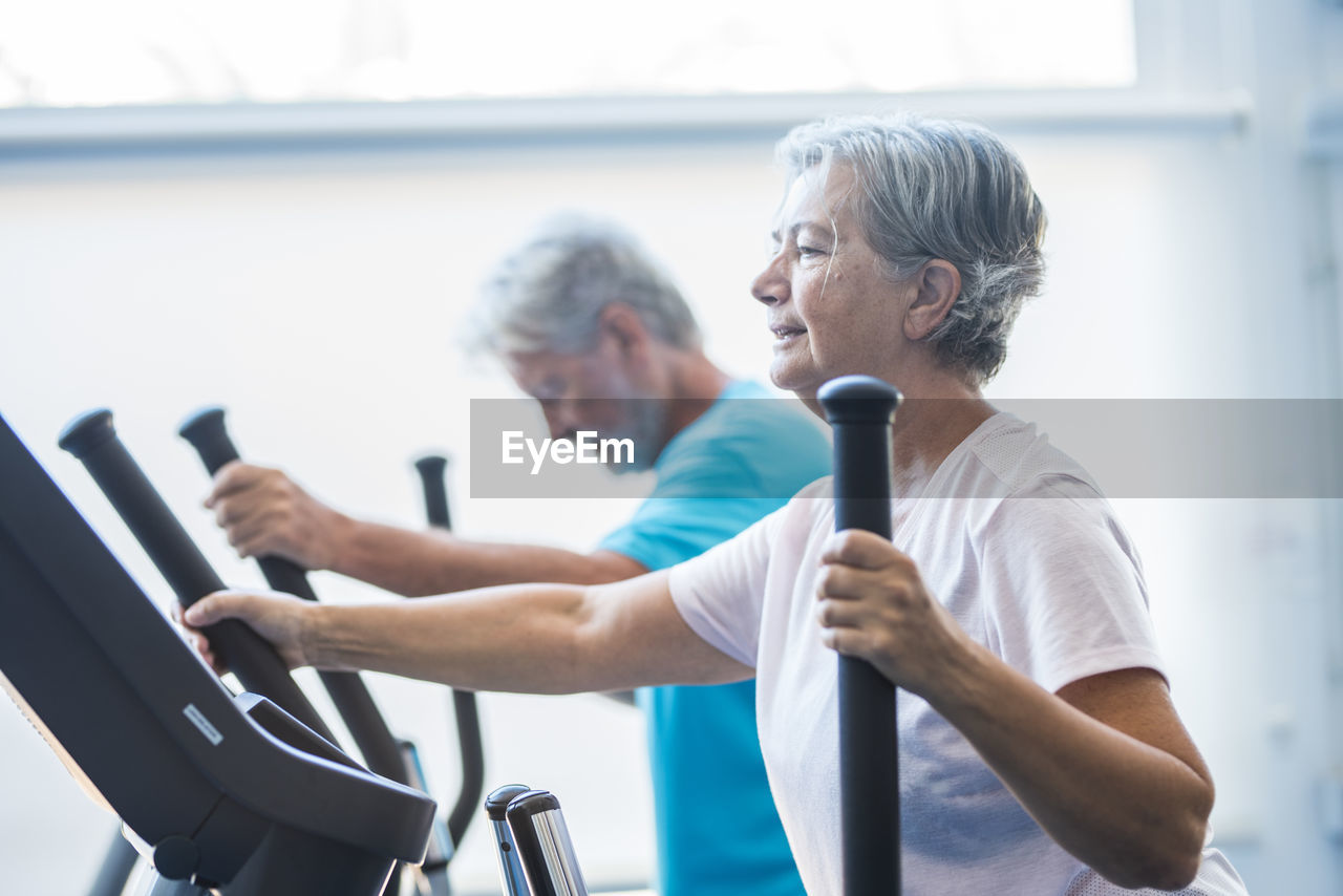 Senior people exercising in gym