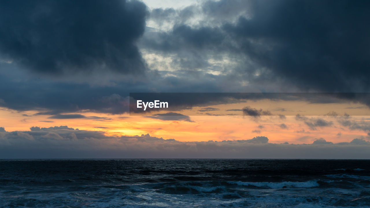 SCENIC VIEW OF SEA DURING SUNSET