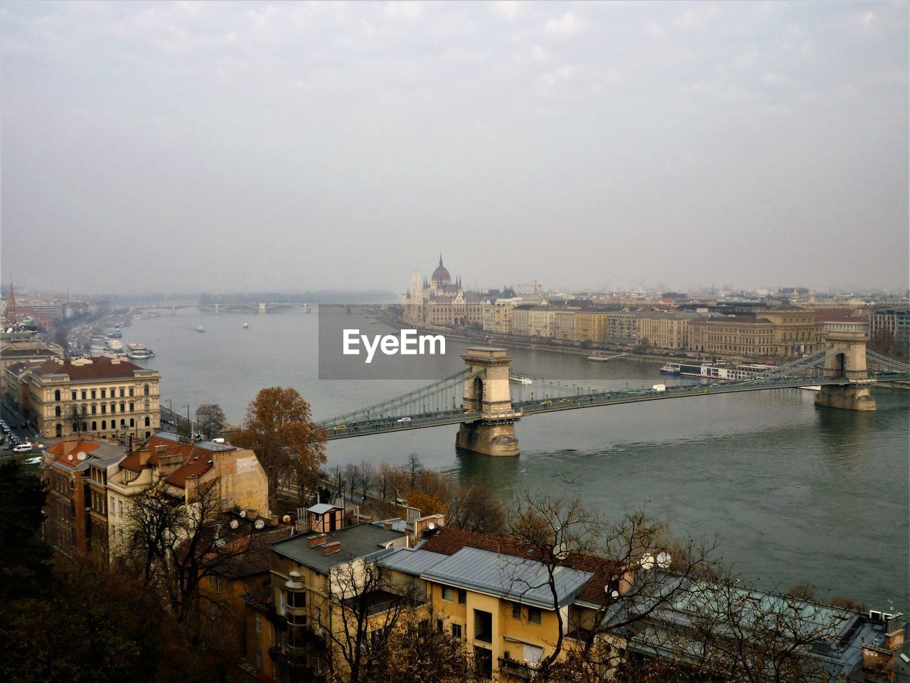 High angle view of bridge over river by buildings in city