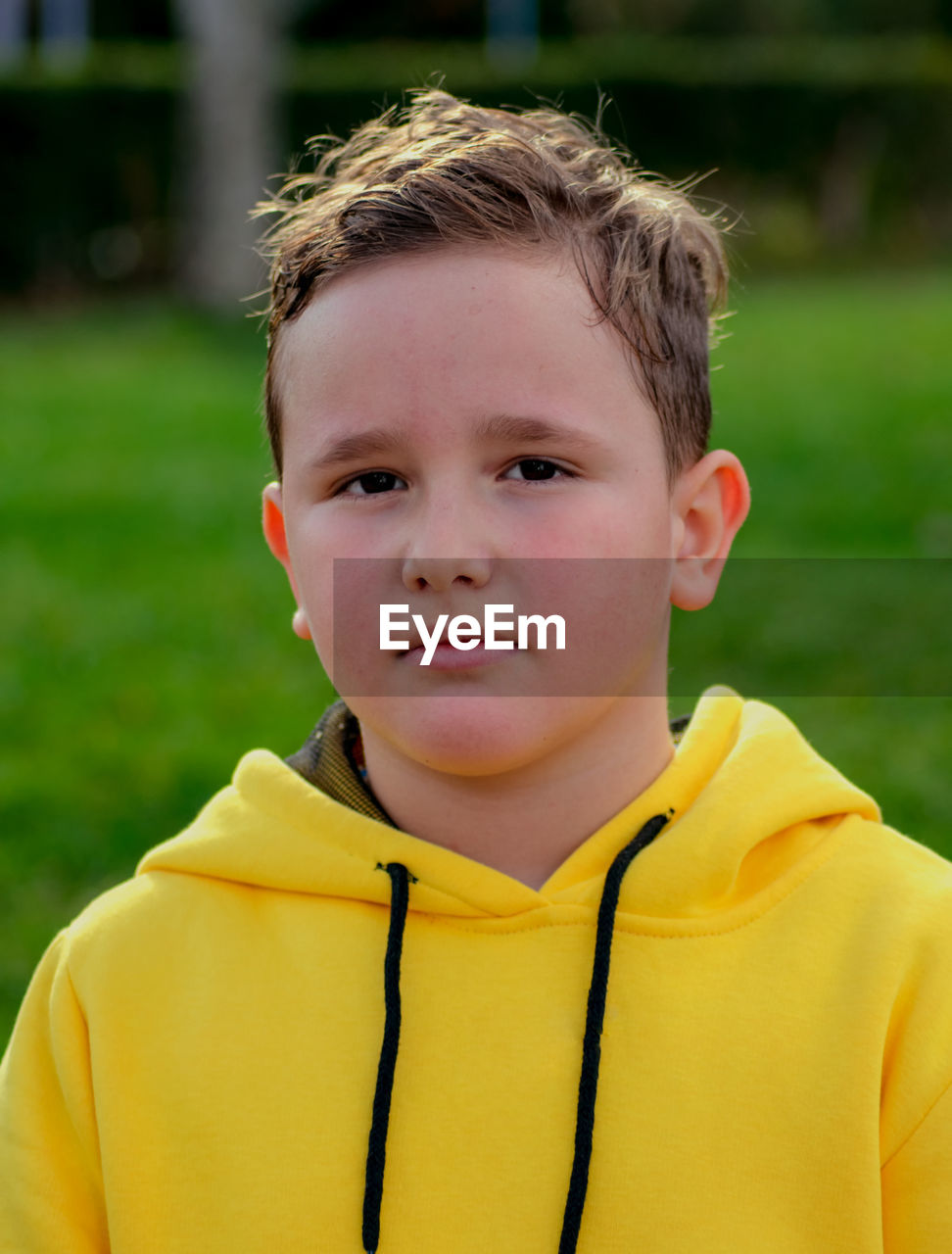 CLOSE-UP PORTRAIT OF BOY WITH YELLOW EYES