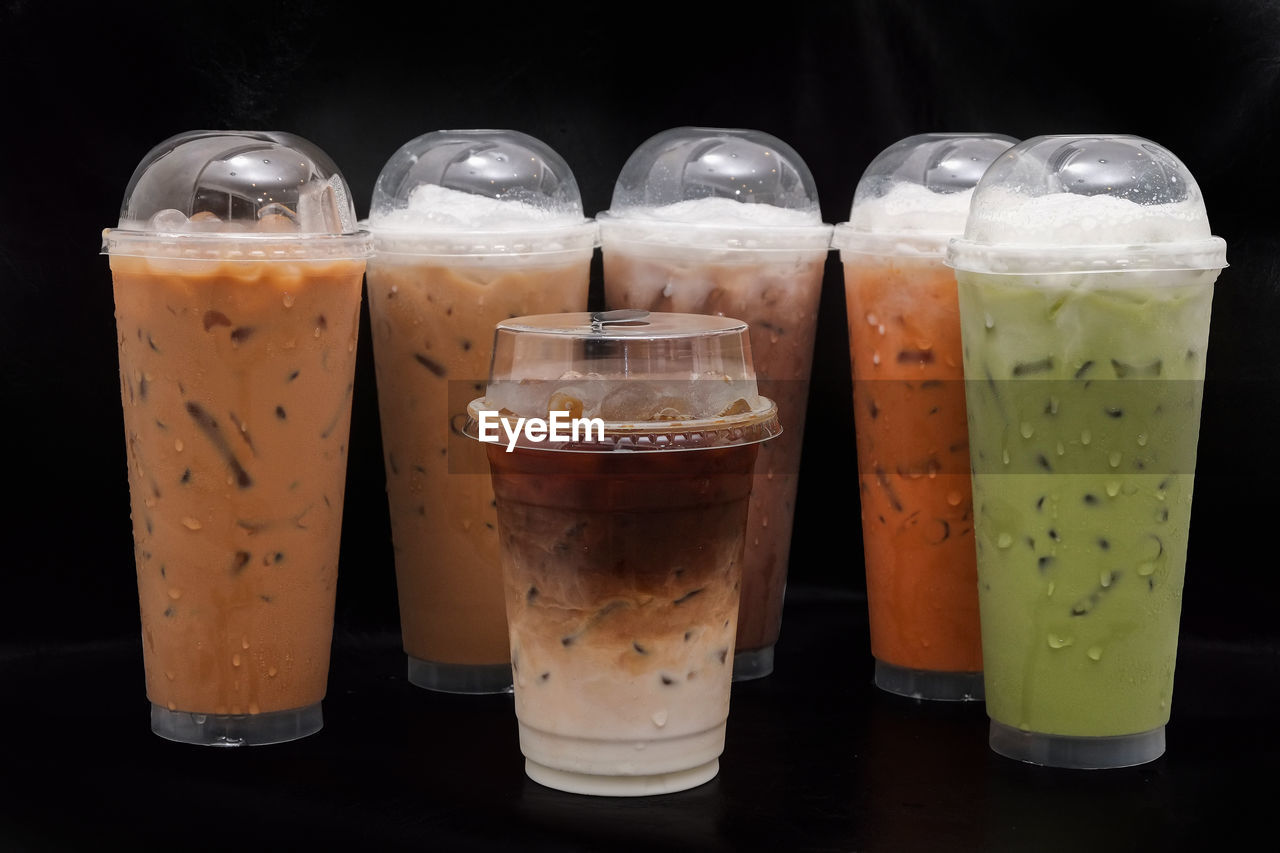 food and drink, drink, soft drink, refreshment, glass, drinking glass, household equipment, food, cold temperature, alcoholic beverage, milkshake, indoors, no people, freshness, still life, black background, frappé coffee, alcohol, healthy eating, juice, studio shot, beer, latte, cold drink