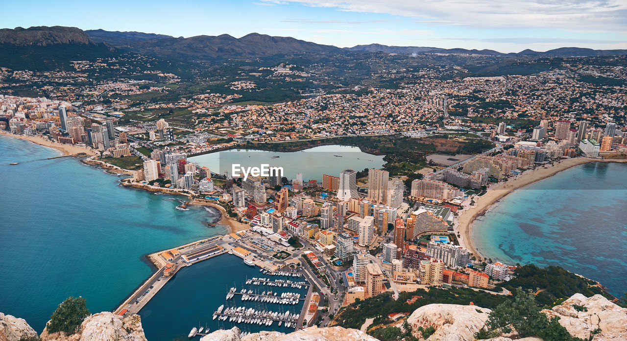 Aerial view of city and buildings against sky