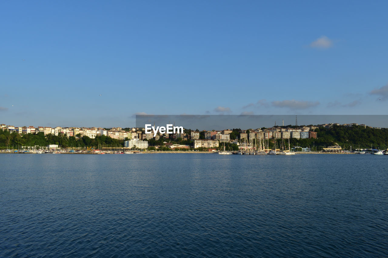 water, architecture, building exterior, sky, built structure, horizon, city, building, sea, nature, no people, body of water, shore, blue, cityscape, coast, travel destinations, waterfront, dusk, bay, residential district, land, day, outdoors, clear sky, beach, travel, scenics - nature, house, tranquility, town, beauty in nature, reflection, landscape, ocean, copy space, cloud, vehicle, tourism